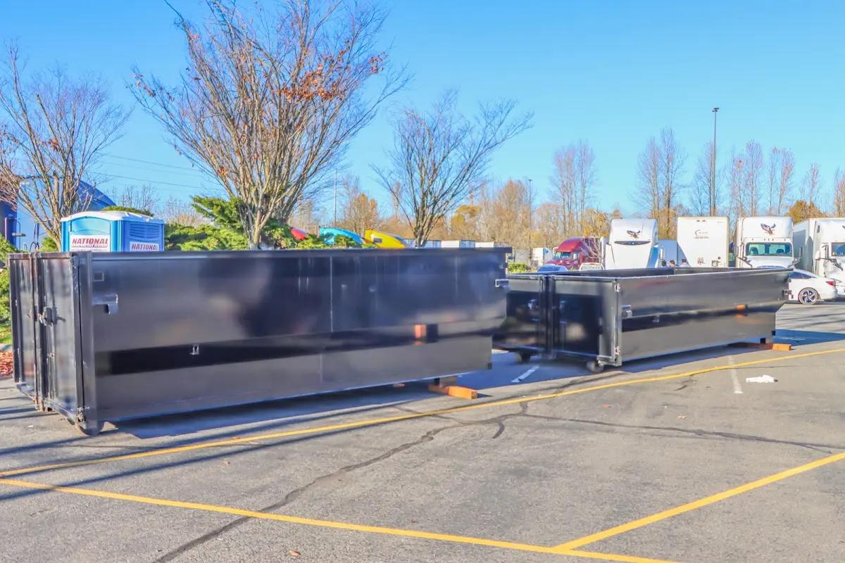 Professional dumpster rental service with roll-off container on residential driveway in Matawan